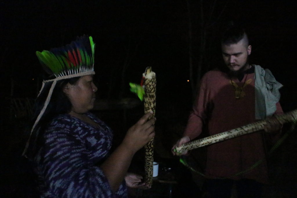 Paulina demonstrating a rain stick to Mateus